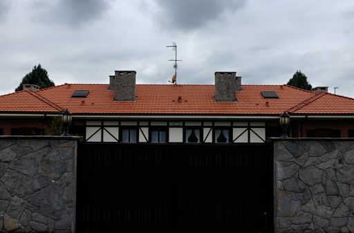 A low angle shot of walls and ceramic roof tiles on a cloudy day