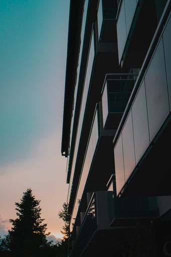 An exterior view of a modern office building at sunset