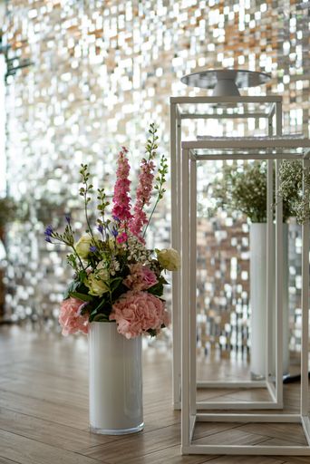 A vertical shot of glass flowers vase on parquet