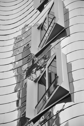 The mirrored metal facade of the Gehry buildings at the Media Harbour in Dusseldorf, Germany