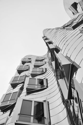 The mirrored metal facade of the Gehry buildings at the Media Harbour in Dusseldorf, Germany