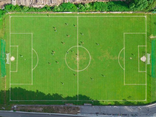 An aerial top view of a football field with players