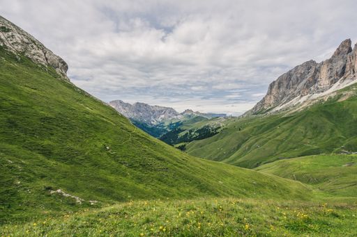 A low angle shot of a mountainous scenery with lots of hills and valleys in Dolomites, Italy