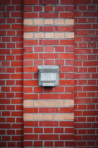 A vertical shot of a brick wall for background texture or wallpaper