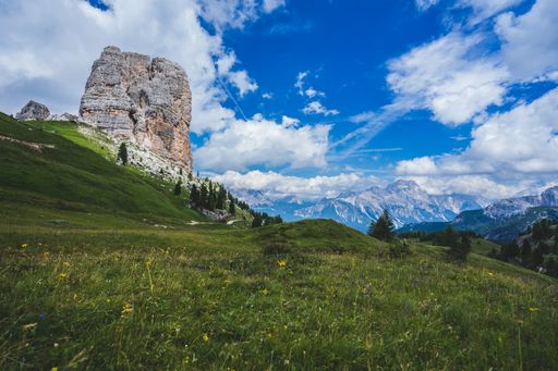 A low angle shot of the famous Cinque Torri rock formation in the middle of green scenery in Dolomites, Italy