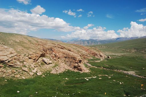 A stunning natural landscape with a beautiful valley surrounded by mountains in the background
