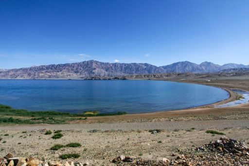 A scenic view of the seascape, featuring a rocky shoreline and tranquil, blue waters