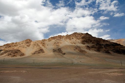 An aerial view of desert surrounded by mountains
