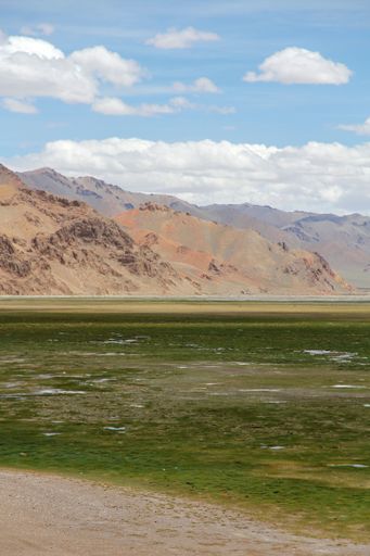 An aerial view of lake surrounded by mountains