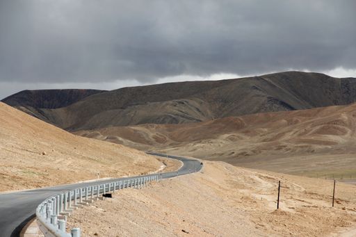 An aerial view of desert surrounded by mountains