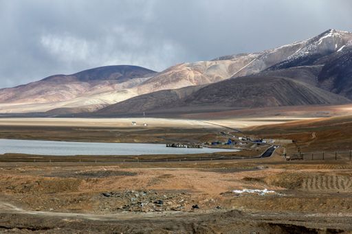 An aerial view of lake surrounded by mountains