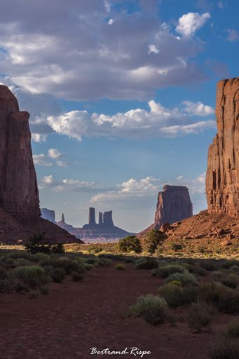 A beautiful scenery with a lot of bushes and rock formations under the cloudy sky