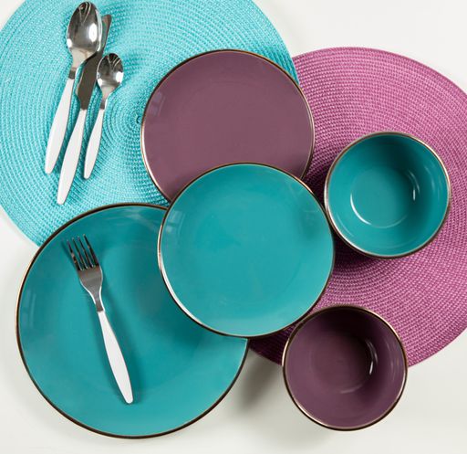 A top view of bright colorful kitchen plates and utensils