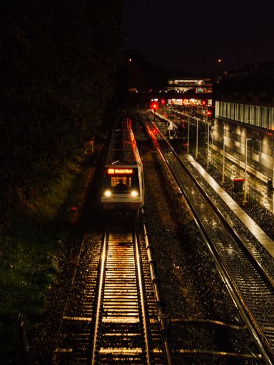 A vertical shot of the Hamburg city train at the train station at night