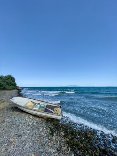 beached white boat from the sea