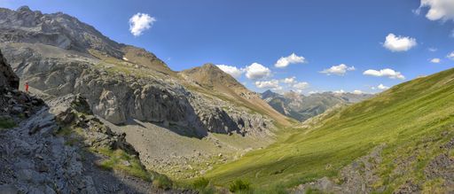 A panoramic view of a valley surrounded by majestic mountains. Ordesa y Monte Perdido National Park.