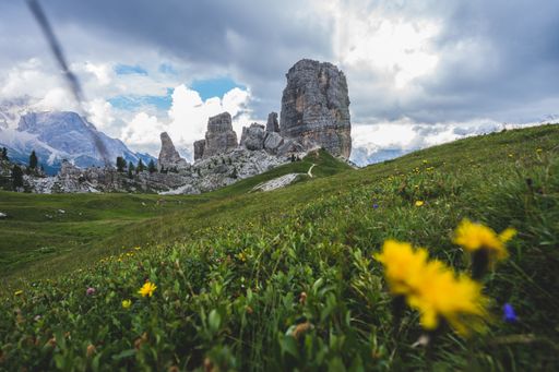 A low angle shot of the famous Cinque Torri rock formation in the middle of green scenery in Dolomites, Italy