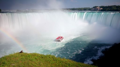 An aerial view of a tourism boat near the splashing beautiful Niagara Falls in Canada