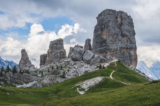 A low angle shot of the famous Cinque Torri rock formation in the middle of green scenery in Dolomites, Italy