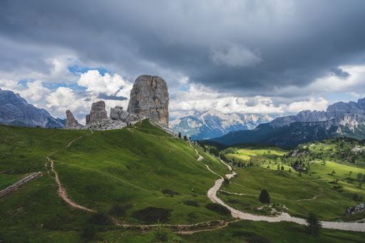 A low angle shot of the famous Cinque Torri rock formation in the middle of green scenery in Dolomites, Italy