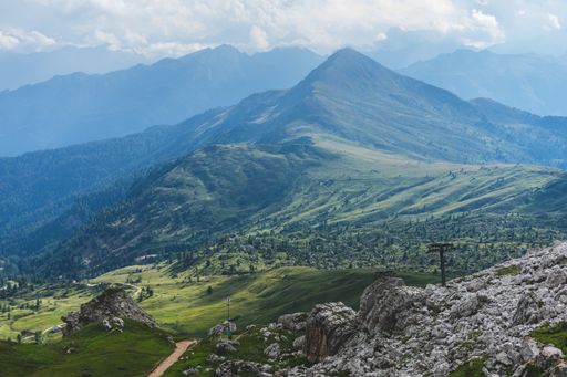 A breathtaking green mountainous scenery under the cloudy sky in Dolomites, Italy.