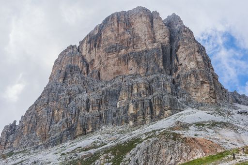 A low angle shot of a rock formation under the cloudy sky in the Dolomites, Italy
