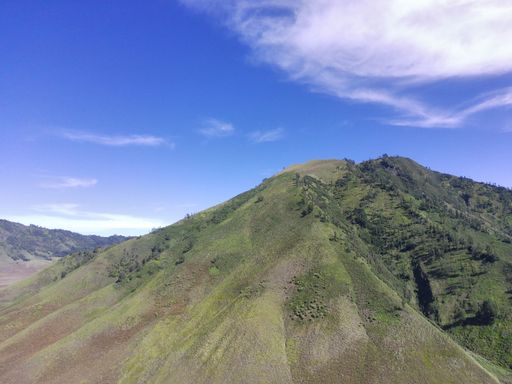 An aerial view of the volcanic crater and nearby mountains in East Java, Indonesia