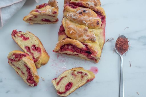A top view of a delicious sliced sweet homemade saffron raspberry babka on a kitchen table