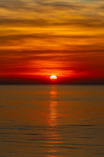 A vertical shot of a sunset over the Black sea - view from a beach in Batumi