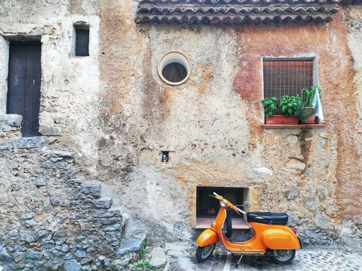 A scooter parked in the historic center in S. Giovanni Piro in Italy