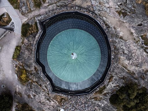 An aerial view of the circular blue roof of the Temppeliaukio Church in Helsinki, Finland