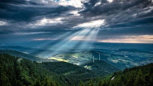 The sun rays through the clouds over the Black Forest in Germany.