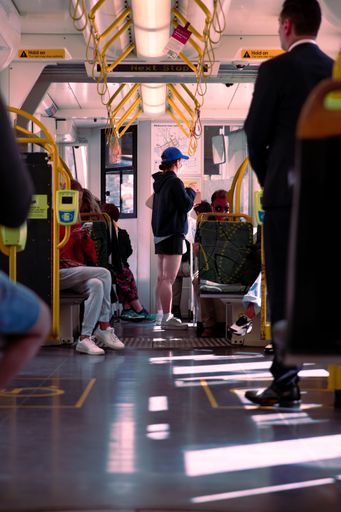 The vertical view of people sitting and standing on the bus