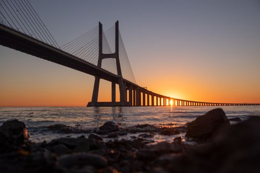 A beautiful scenery of the famous Vasco da Gama bridge at sunset in Lisbon, Portugal
