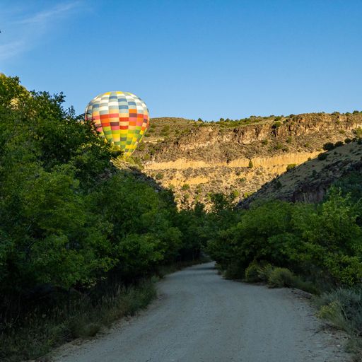 A colorful hot air balloon flying on a sunny day