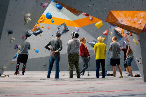 A group of climbers hanging out in climbing gym