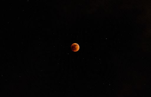 A beautiful view of a moon in the dark black sky at night