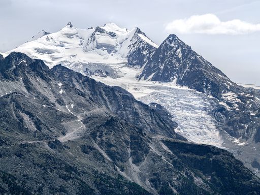 A beautiful shot of snowy mountain peaks under a bright sky in Switzerland