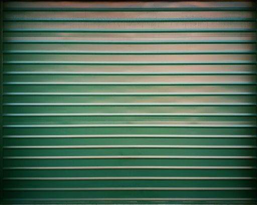 A closeup shot of a green corrugated metal garage door