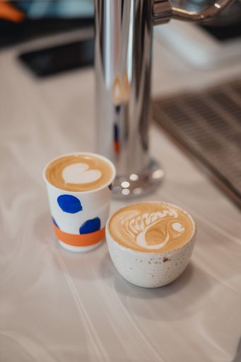 A vertical shot of coffee art latte