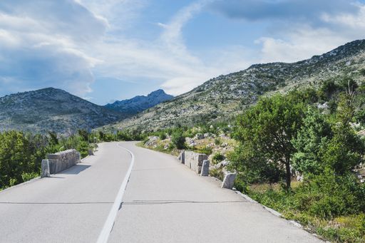 An empty road to Mali Halan, Southern Velebit, winding trough rocky mountains