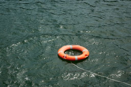 A view of an orange rescue ring buoy in a sea