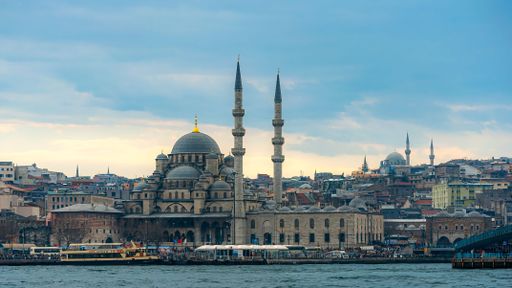 A beautiful shot of the historic Yeni Cami Mosque at dusk in Istanbul, Turkey