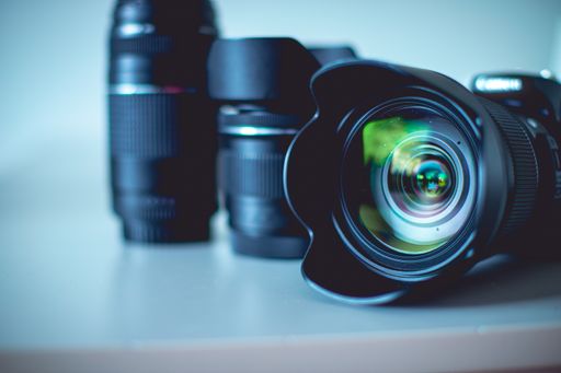 A closeup of a digital camera with lenses