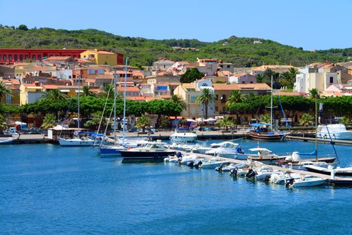 Yachts and leisure / pleasure boats, viewed from sea, moored at a Mediterranean marina (in Carloforte, Isola di San Pietro, Sardinia, Italy).