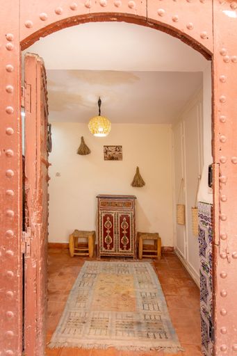 A vertical shot of the Moroccan old door of an old guest house in Marrakech Medina