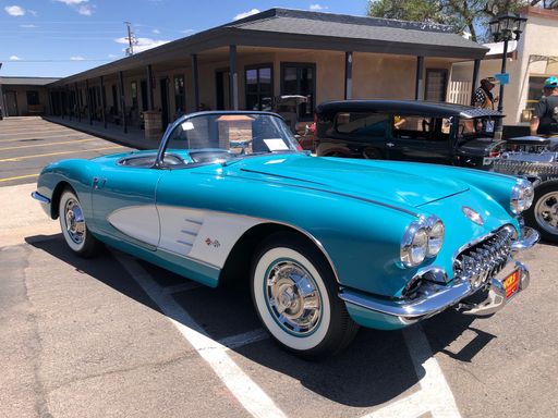 A beautiful classic blue Chevrolet Corvette on the road during a car show in Williams