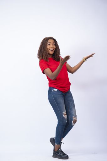 A vertical shot of a young black female feeling delighted