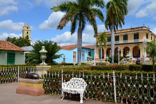 Formal gardens in Plaza Mayor, Trinidad de Cuba, Cuba. Image includes people walking in these gardens.