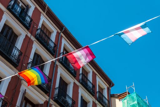Several lgbtq flags hanging in the streets and balconies at the pride party in Madrid, Spain